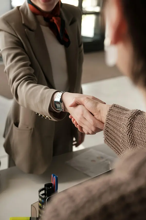 two people shaking hands in an office
